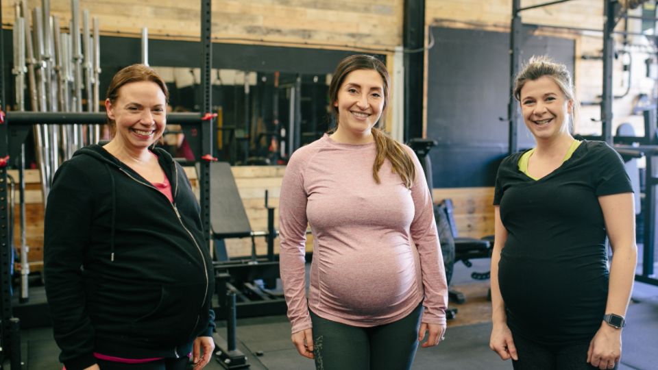 three pregnant women in a gym